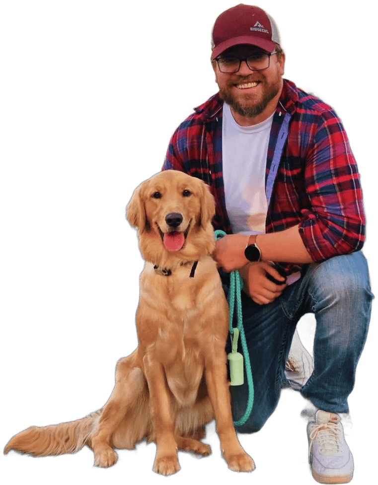Ben kneeling beside a happy golden retriever